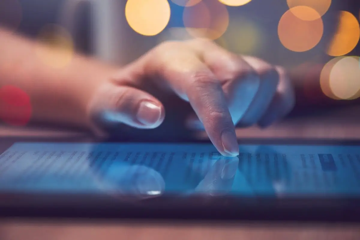 a hand touching a touch screen