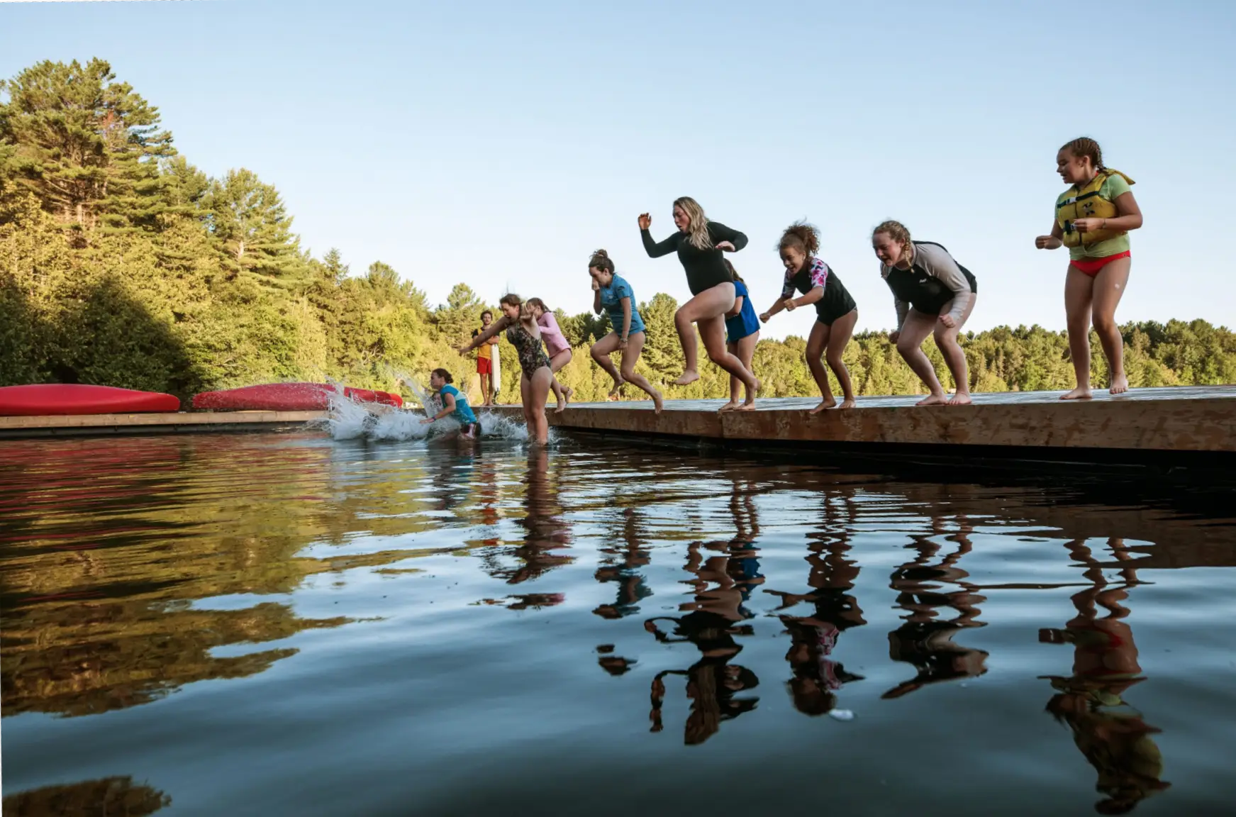 a group of people jumping into water