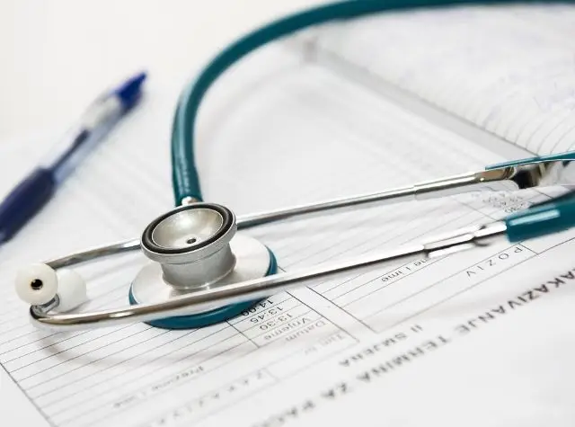 a stethoscope on top of a medical form