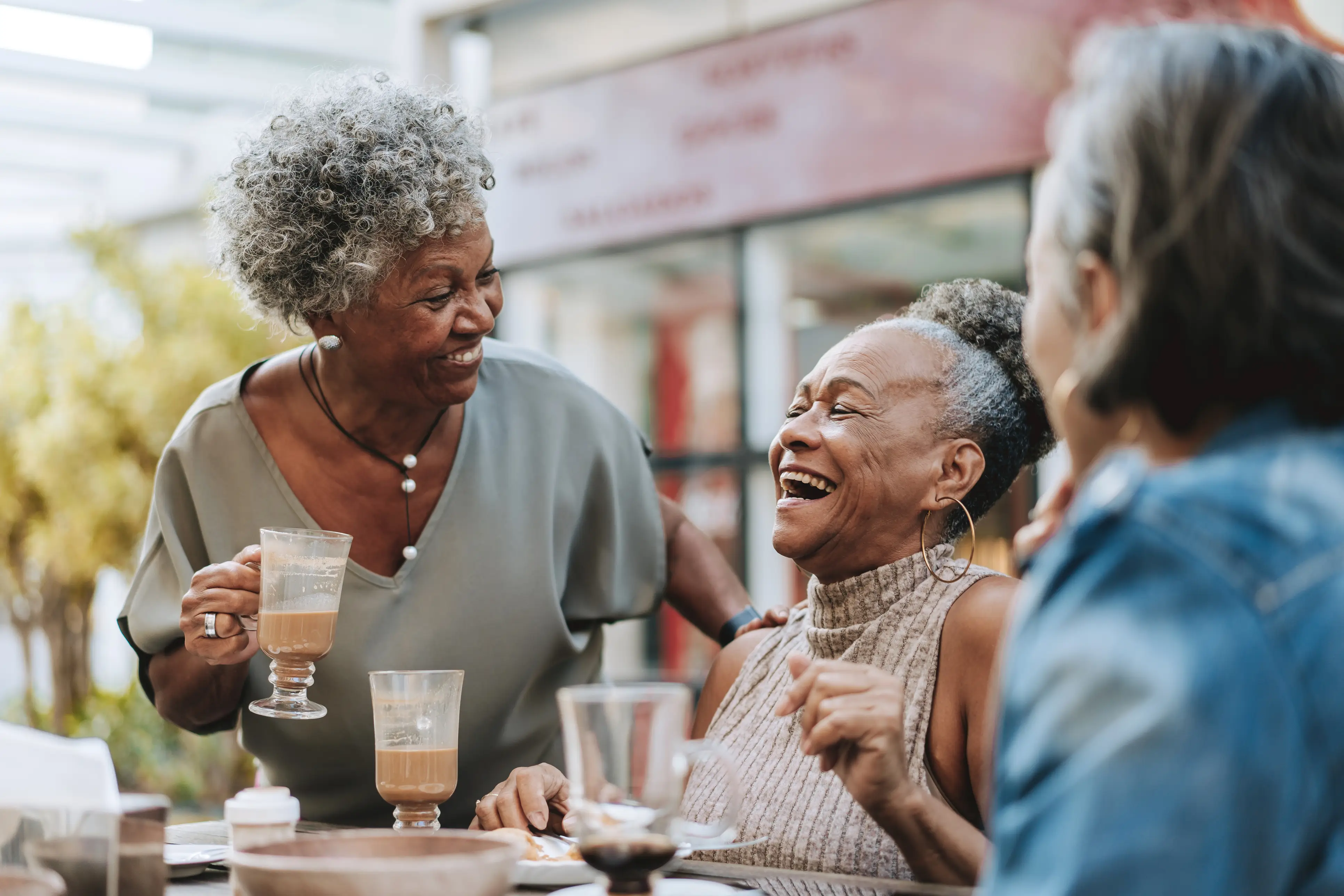 a group of women laughing at a table