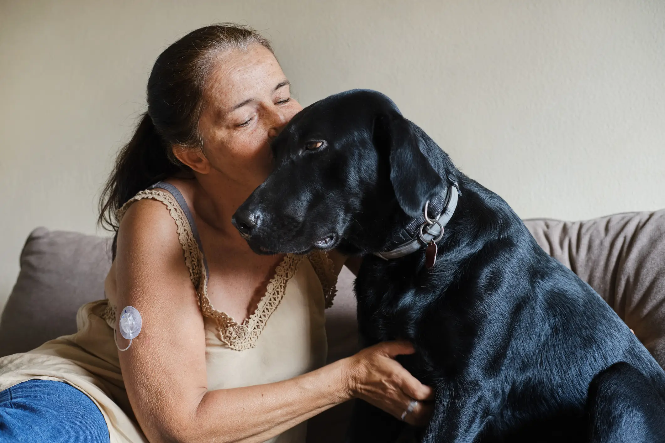a woman sitting on a couch with a dog