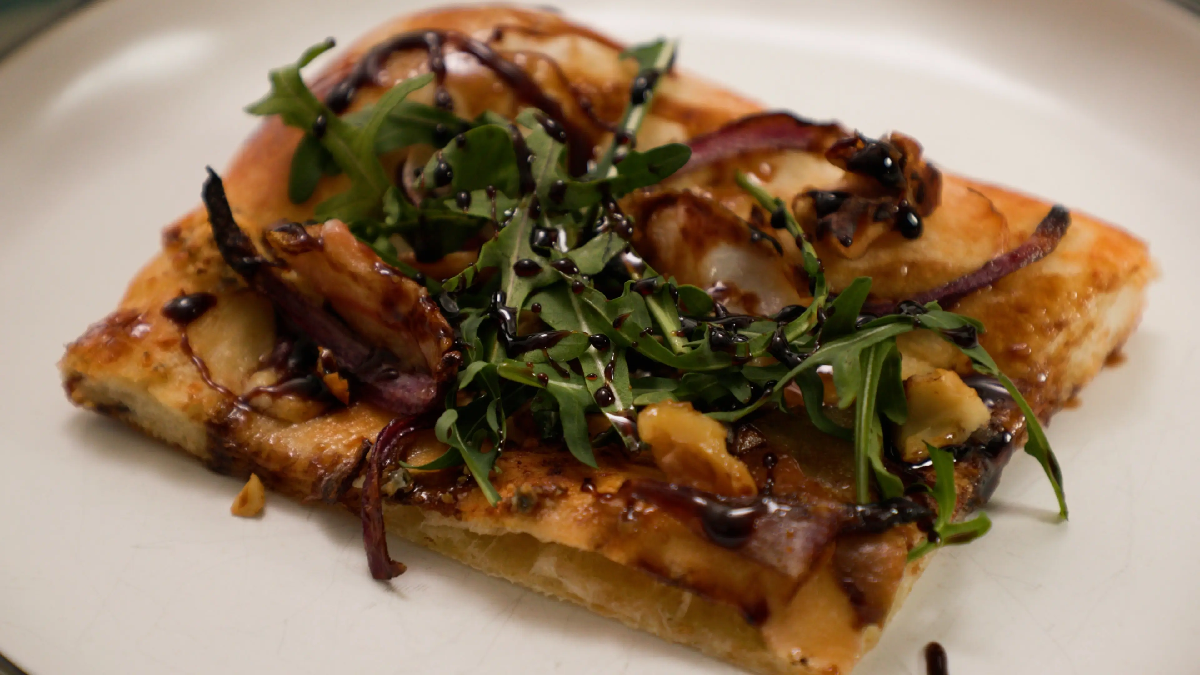 Pear and walnut flatbread with gorgonzola, arugula, and balsamic glaze